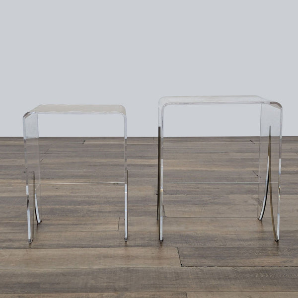 1. Pair of clear acrylic waterfall end tables with antique brass inlay, Gabby Magnolia brand, on wood floor.