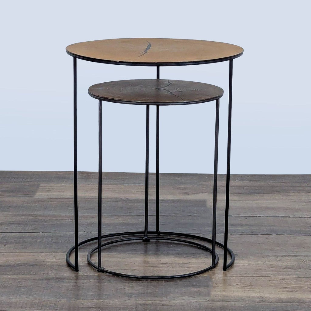 1. Set of two round Reperch side tables with slim black metal frames and wooden tops, one nested below the other.