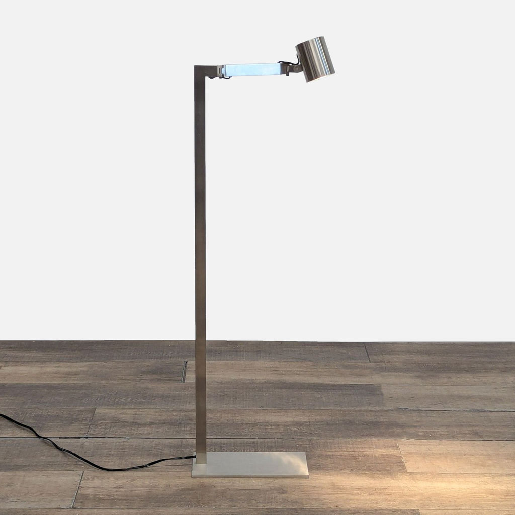 Chrome floor lamp with adjustable arm by Christian Liaigre, part of the Lighting collection.  