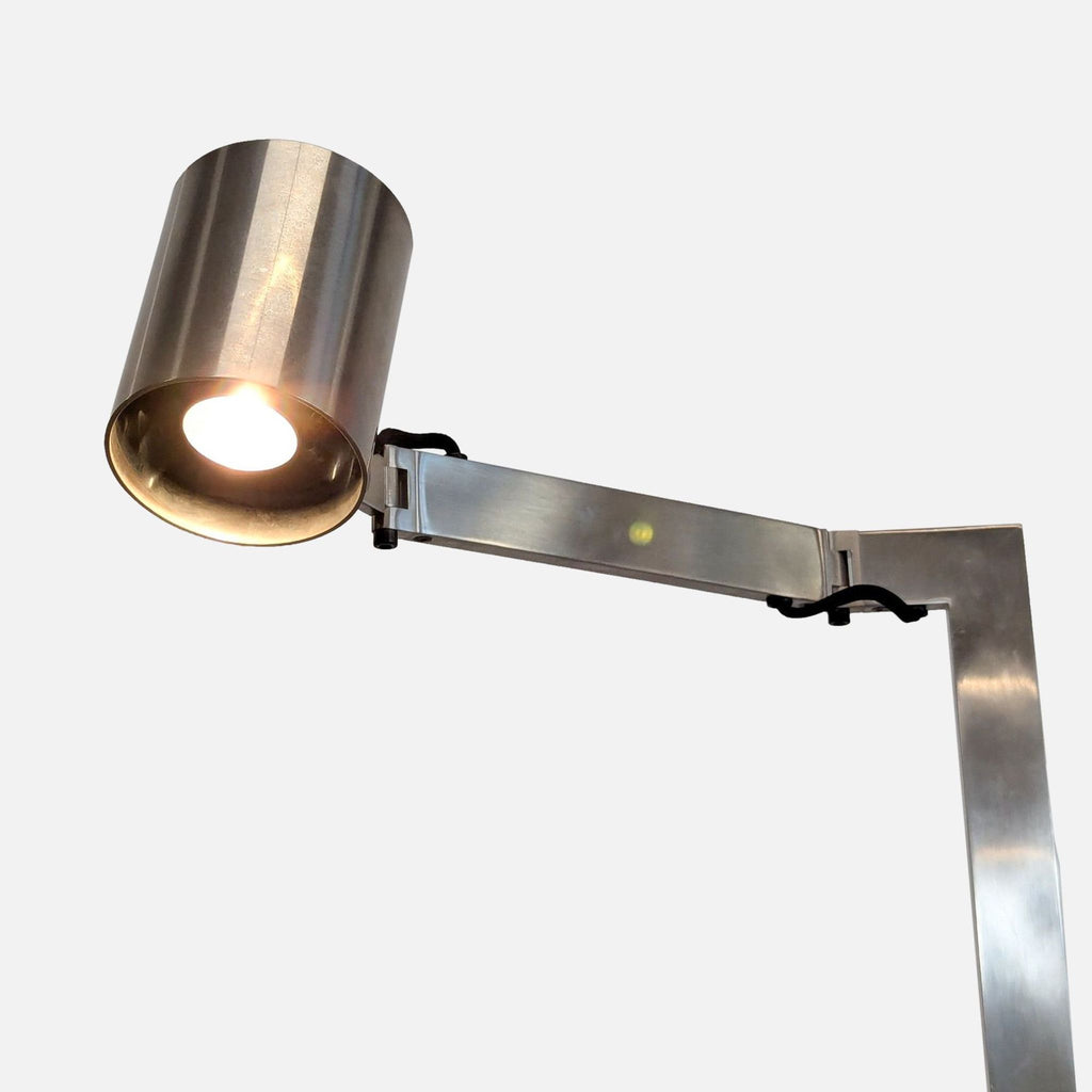 Sleek Christian Liaigre chrome floor lamp featuring an adjustable arm for directional lighting.  