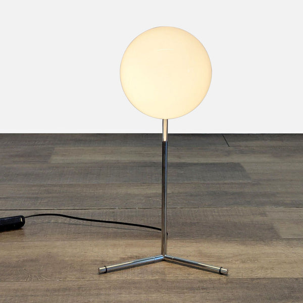 Modern Reperch table lamp with a chromed steel frame and round blown glass opal diffuser on tripod base.