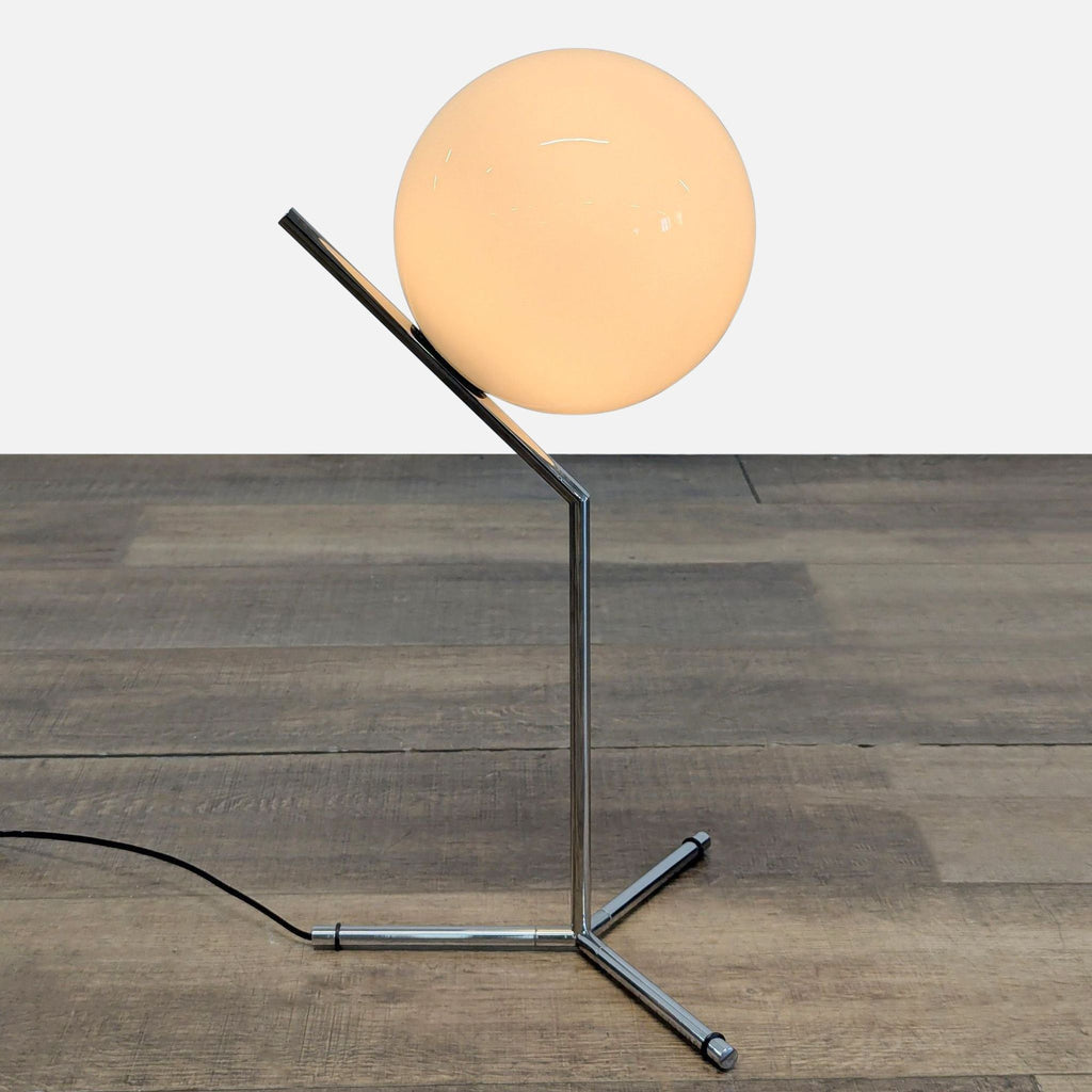 3. Modern lighting fixture by Michael Anastassiades featuring a chromed steel frame and spherical opal glass diffuser.