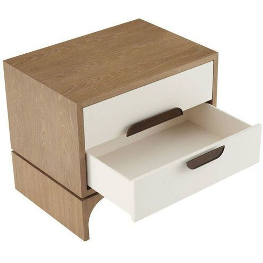 2. Oak wood side table from Arteriors Home, featuring white drawers and modernist brass handles, one drawer open.