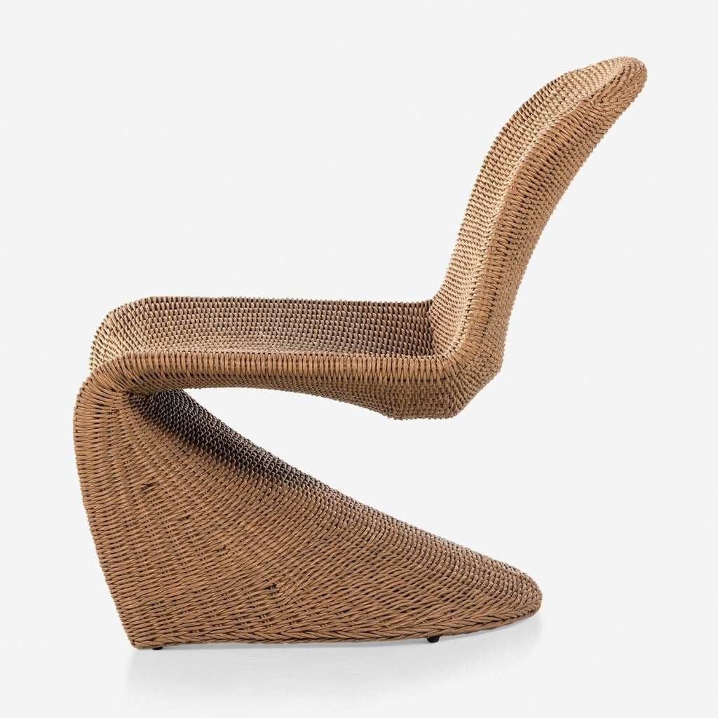 Side profile of a Lulu and Georgia wicker chair showcasing its modern, curved scoop seat design.