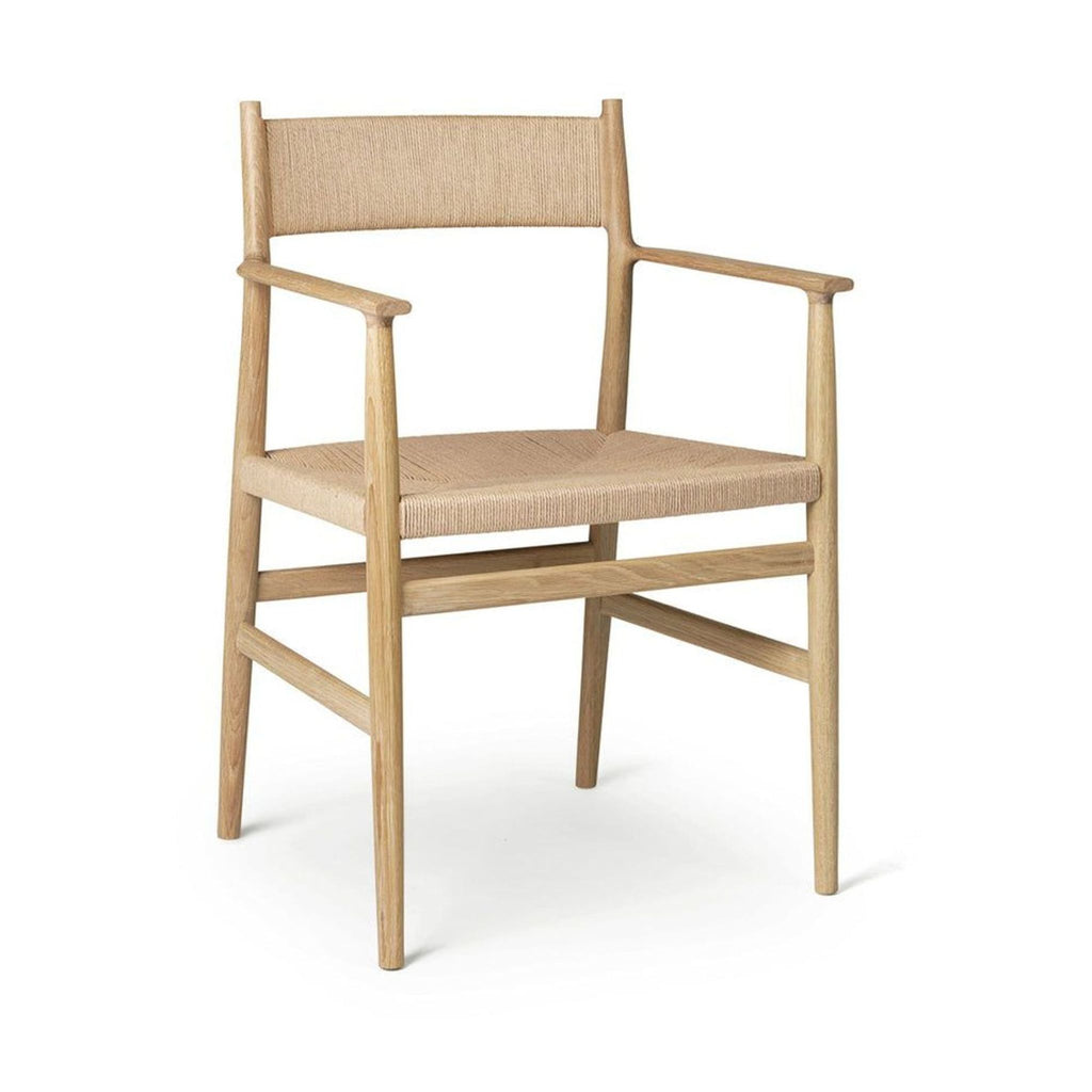 1. Arv dining chair with hand-woven cord seat, sculpted backrest, and oak wood frame, designed for comfort.
