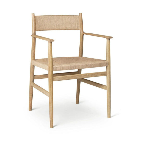 1. Arv dining chair with hand-woven cord seat, sculpted backrest, and oak wood frame, designed for comfort.