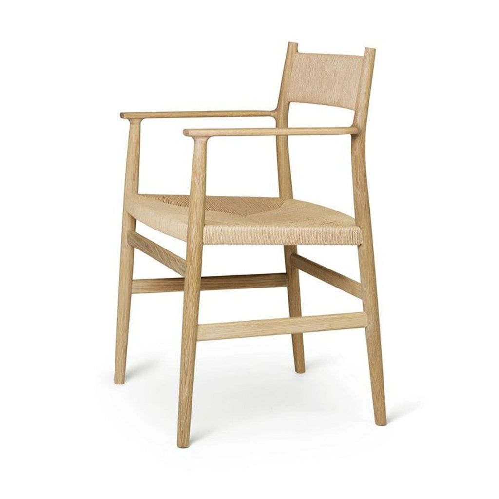 2. Side view of the Arv solid oak dining chair, featuring a woven cord seat and ergonomic wooden armrests.