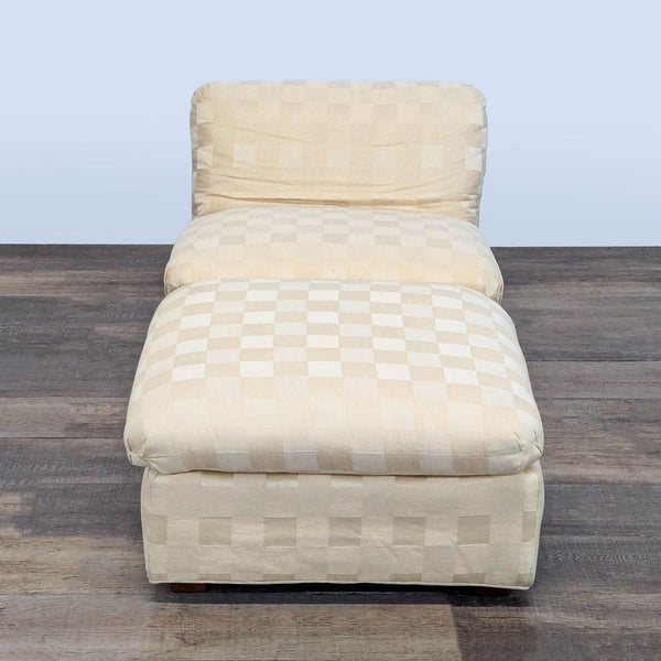 1. Cream Reperch lounge chair and ottoman with soft checkered upholstery, viewed from the front.