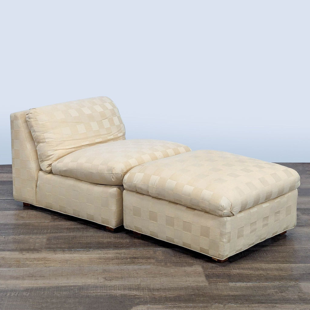3. Angled view of cream upholstered Reperch lounge chair and ottoman on a wooden floor.