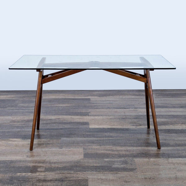 1. West Elm desk with a solid wood A-frame base and glass top, shown from the front on a wood floor.