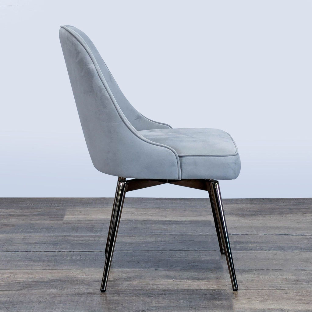 2. Side profile of a modern West Elm chair showing its sloping back and metal legs.