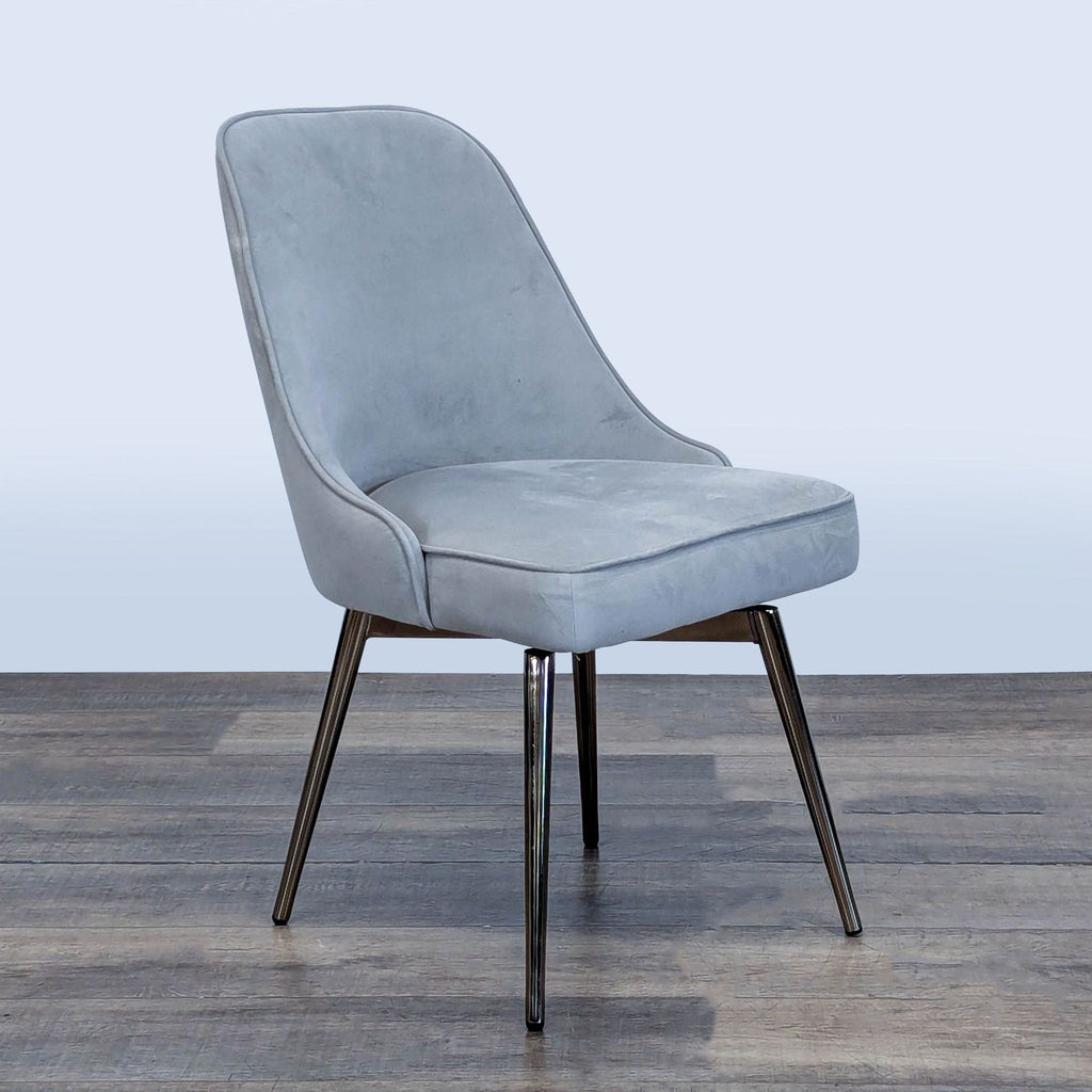 3. Angled view of a West Elm chair featuring a wide swivel seat and sturdy metal base.