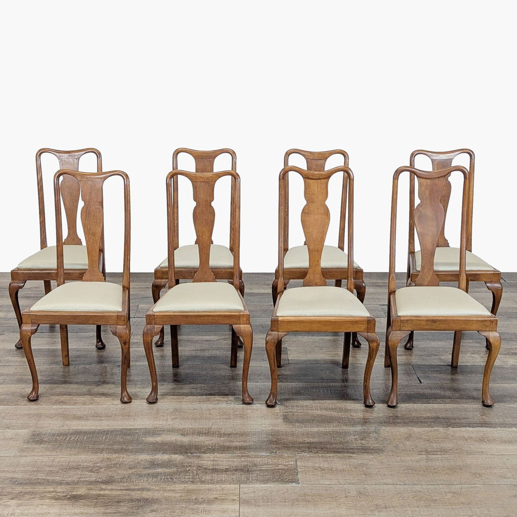Set of six Reperch dining chairs with curved wooden frames and light upholstered seats, arranged on wood floor.  