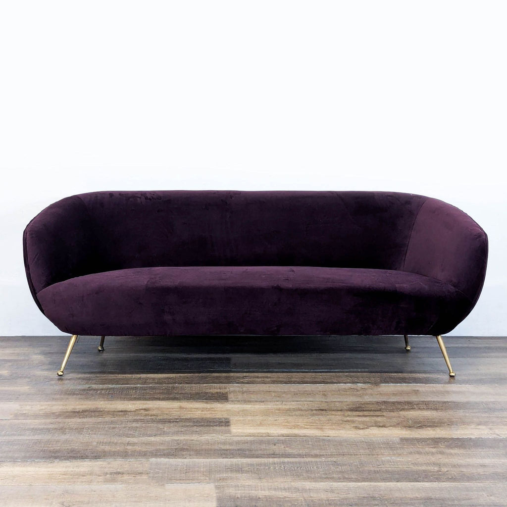 1. Reperch 3-seat sofa with rounded shape, pleated velvet upholstery, and sleek gold pin legs, front view.  