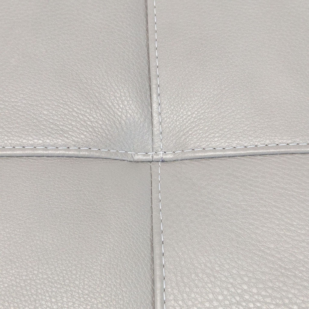 3. Detailed view of the tufted, pebbled grey leather upholstery of the HD Buttercup bench cushion.
