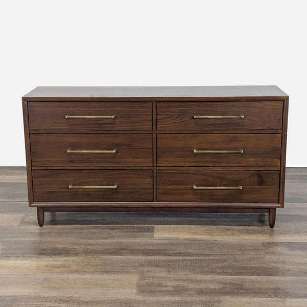 1. Northridge Home walnut dresser with six drawers, brass handles, and a mid-century modern design on wooden floor.
