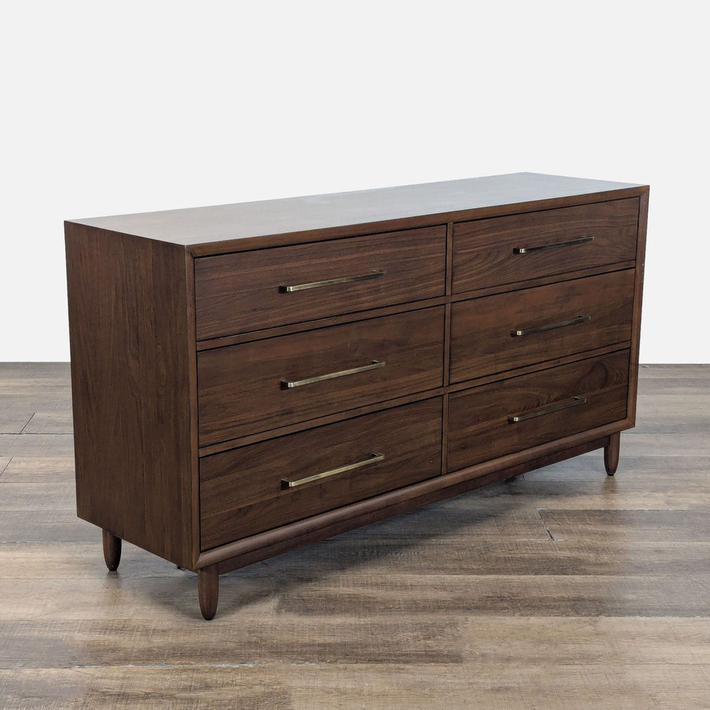 3. Six-drawer walnut dresser from Northridge Home, shown from the side with premium brass handles and tapered legs.