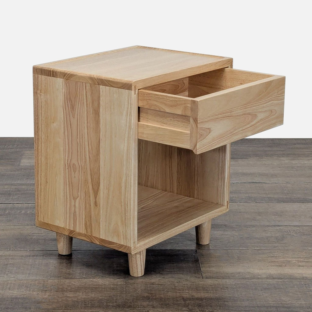 2. Side view of Thuma end table showing the drawer partially open, displaying its simple, natural wood design.  