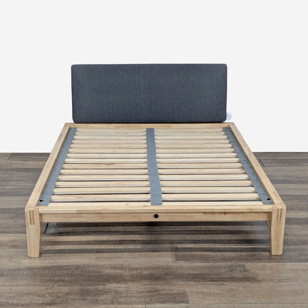 1. Thuma wood platform bed frame with slats, Japanese joinery, and upholstered Pillowboard, shown from the front.