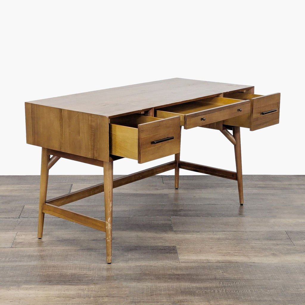 2. West Elm acorn-finish desk angled to show open drawers, featuring sturdy legs and sleek modern design.