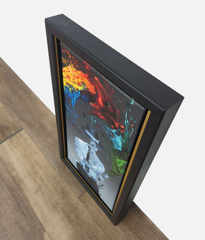 3. Angled top view of a Kevin Kre8 framed print, highlighting the bold colors and modern black-and-gold frame.