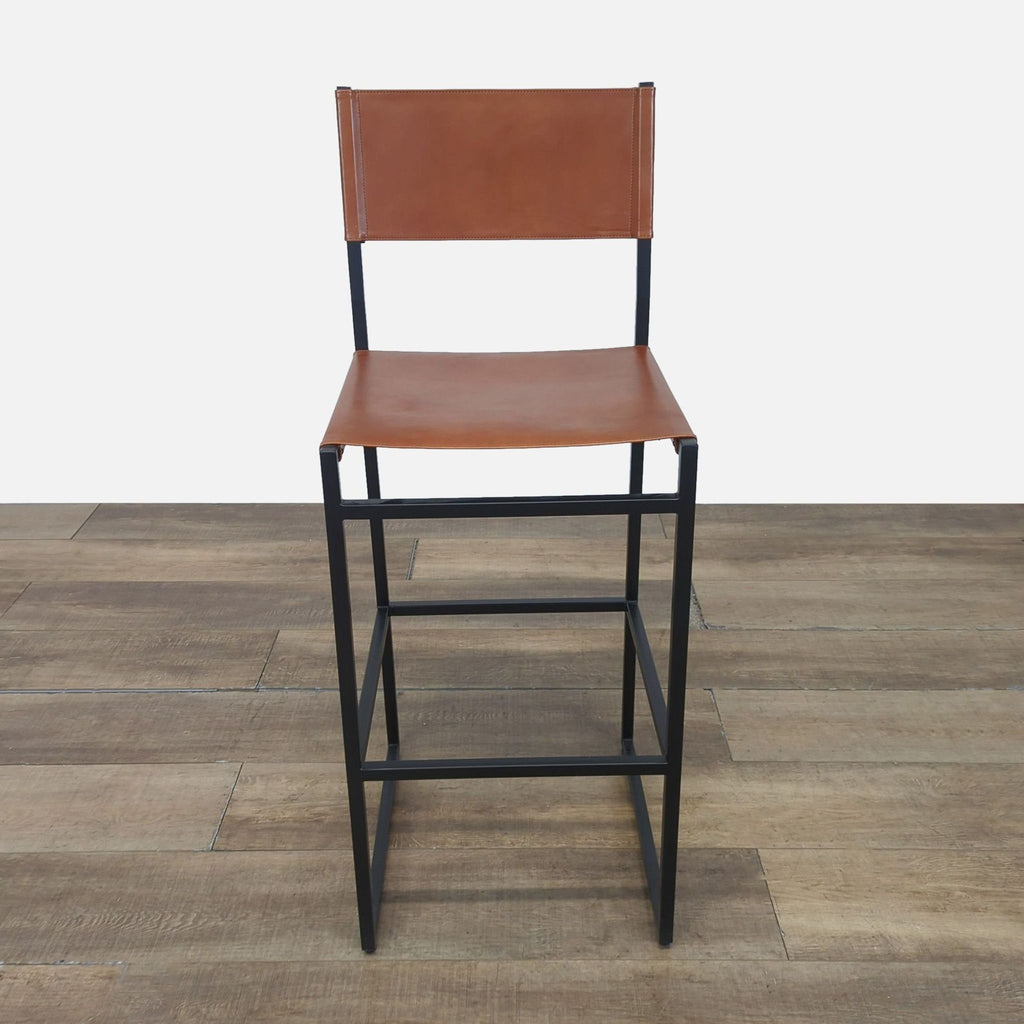 1. Reperch bar stool with brown leather seat and backrest, black metal frame, viewed from the front.