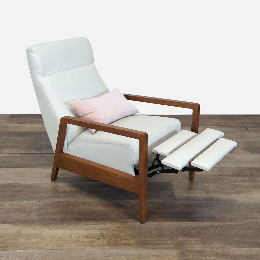 Side view of a Reperch push back recliner lounge chair with extended white leather footrest and wooden frame.  