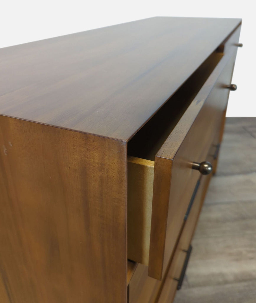 3. Close-up angled view of West Elm wooden dresser, focusing on the craftsmanship and open drawer.