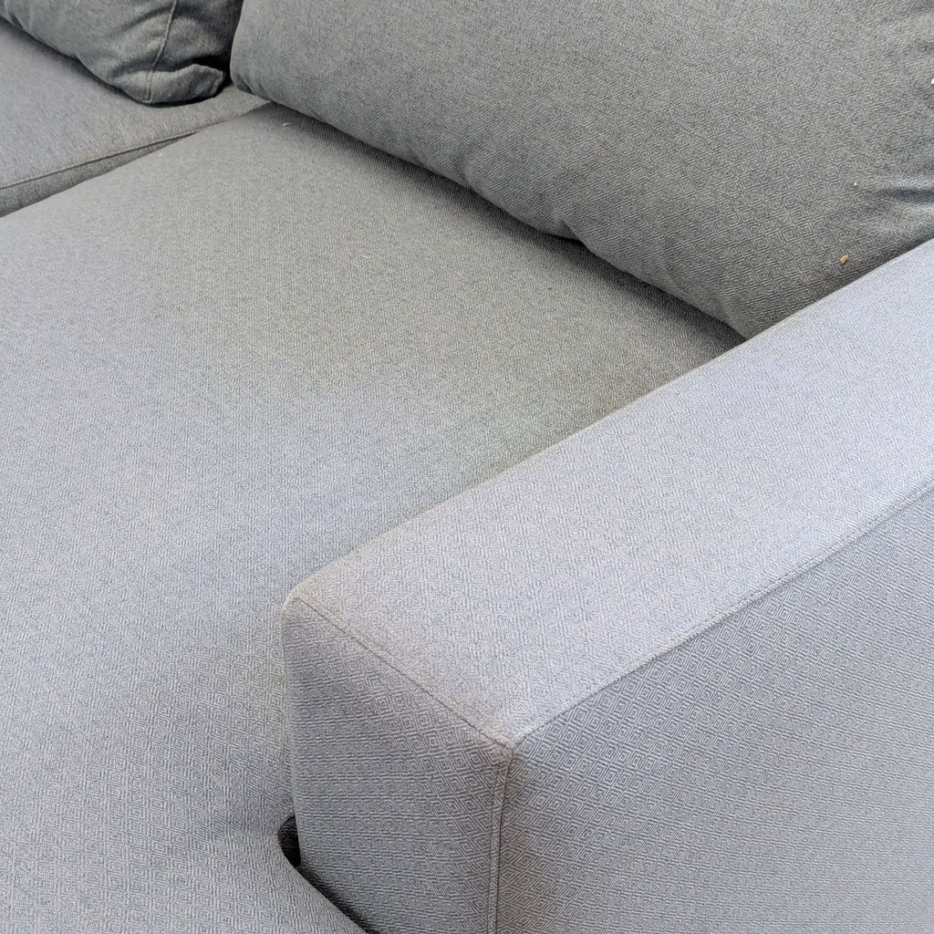 3. Detailed view of textured upholstery and padded armrest on the McCreary Modern sectional sofa.