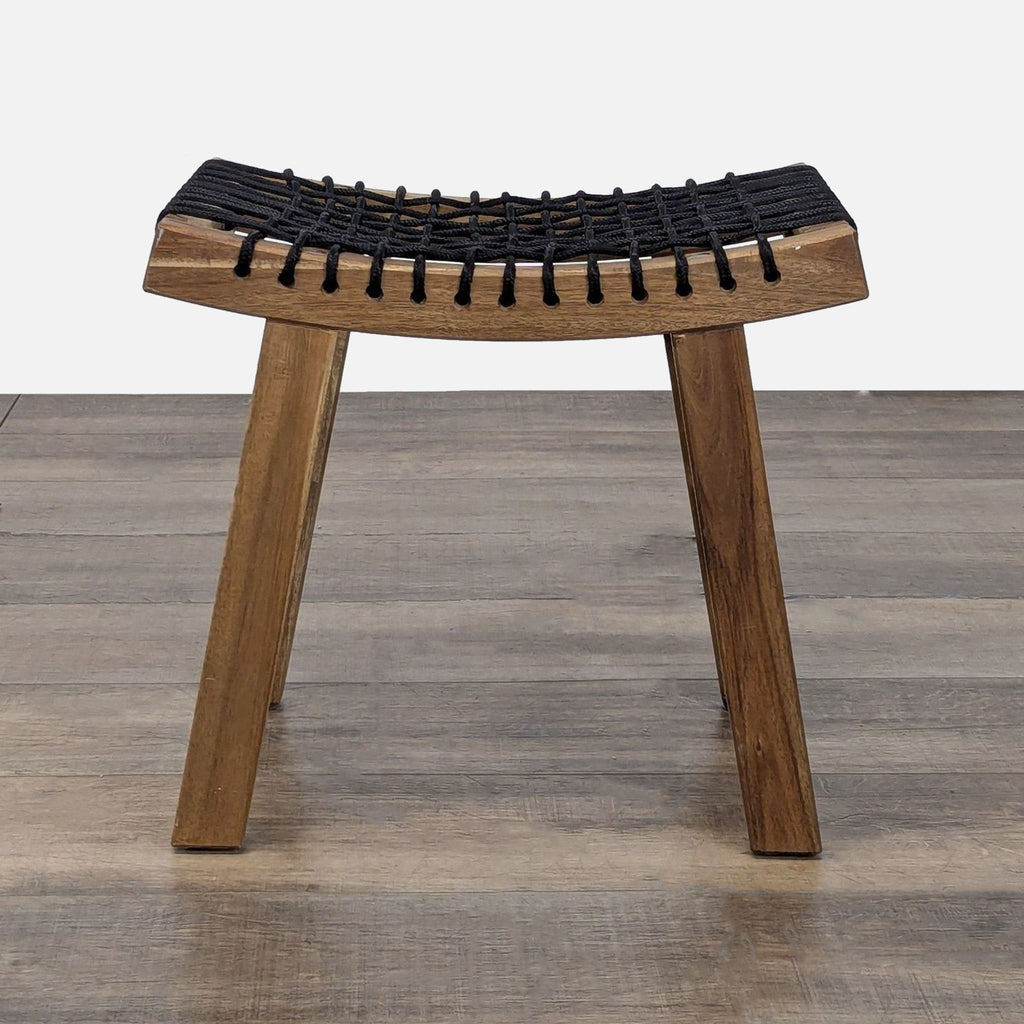 Wooden stool by Reperch featuring a black woven rope seat and minimalist design, shown from the front.  