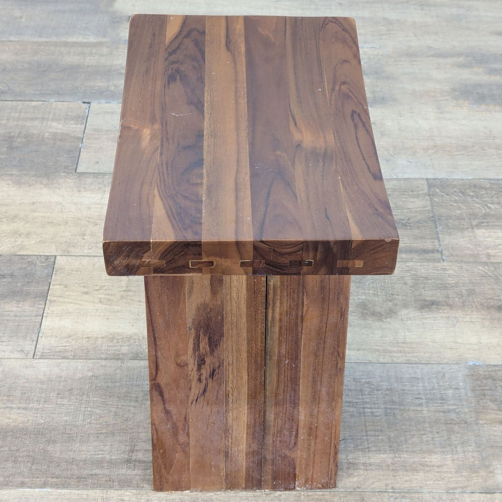 2. Top-down view of a Redmon wooden bench, highlighting the plank construction and wood grain.