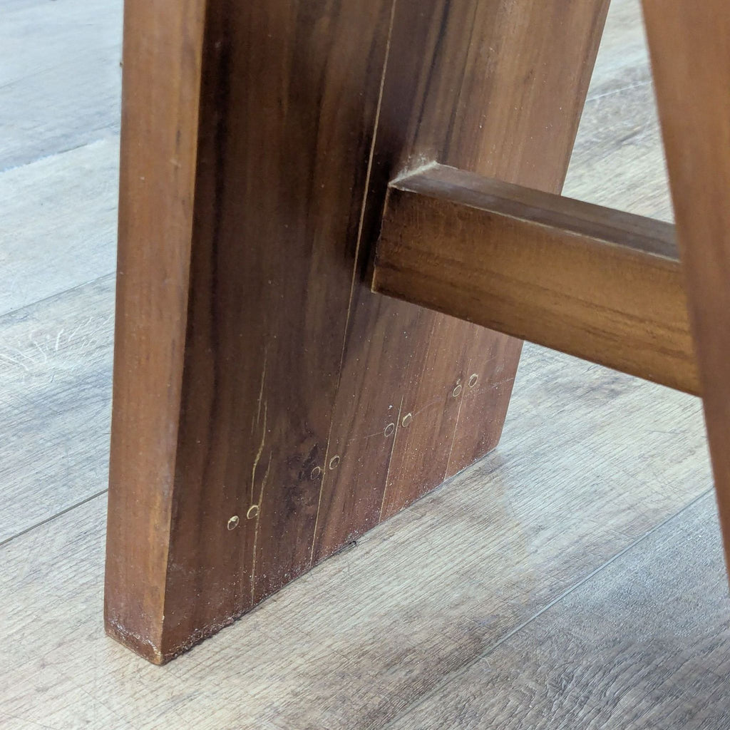 3. Close-up of the leg joinery and wood texture on a Redmon stool, showing craftsmanship details.