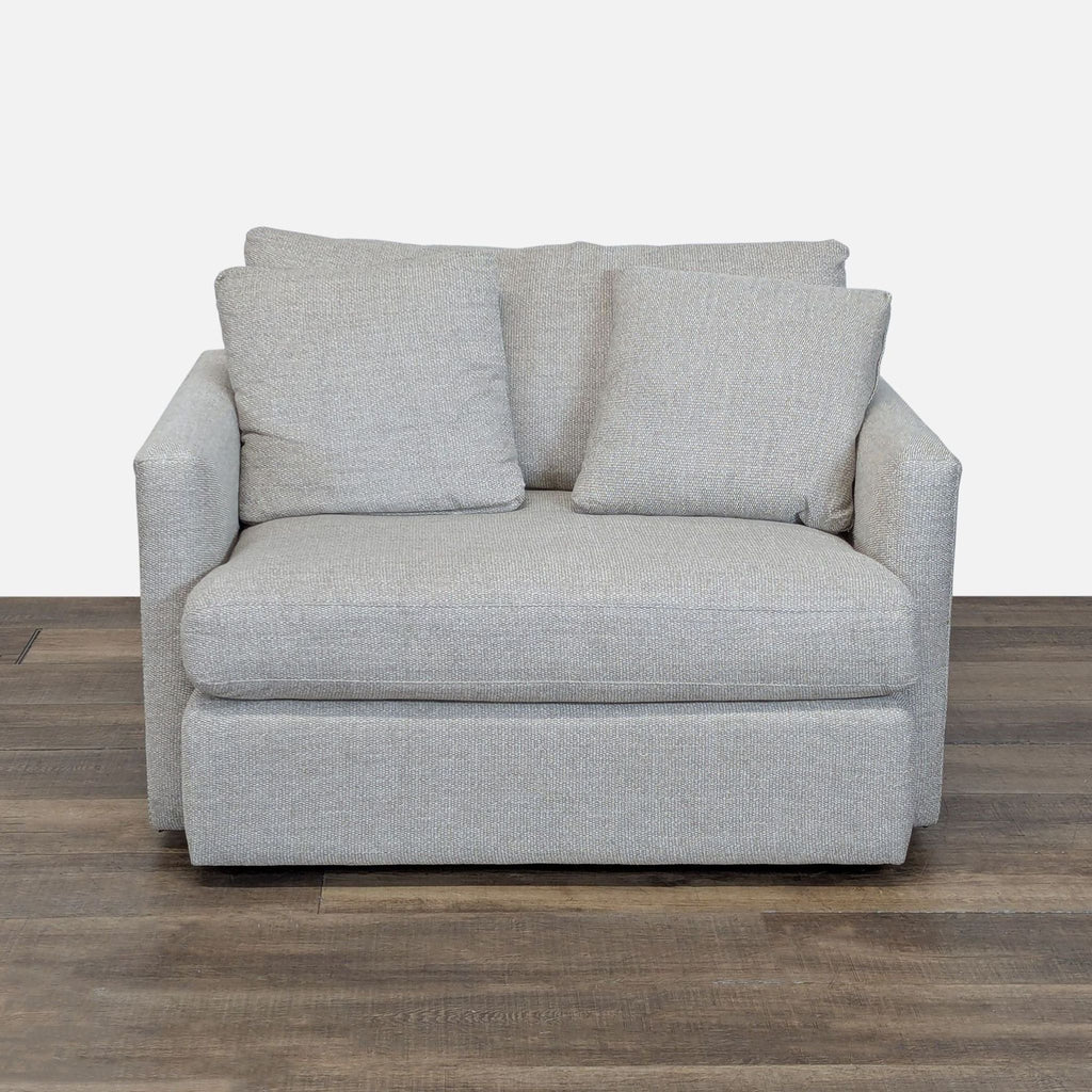 1. Front view of Crate & Barrel loveseat with track arms, plush loose cushions, and matching pillows.