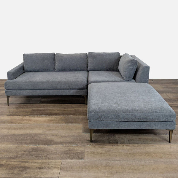 1. Modern West Elm sectional with thin arms, slim seat deck, and tall cast metal legs, shown from the front.  