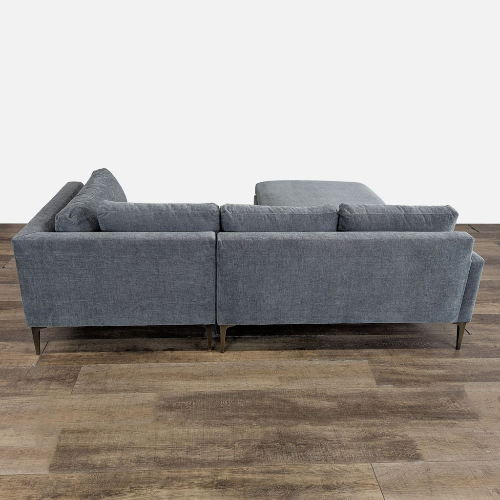 3. Rear view of a West Elm sectional, highlighting slim back cushions, thin arms, and tall metal legs.