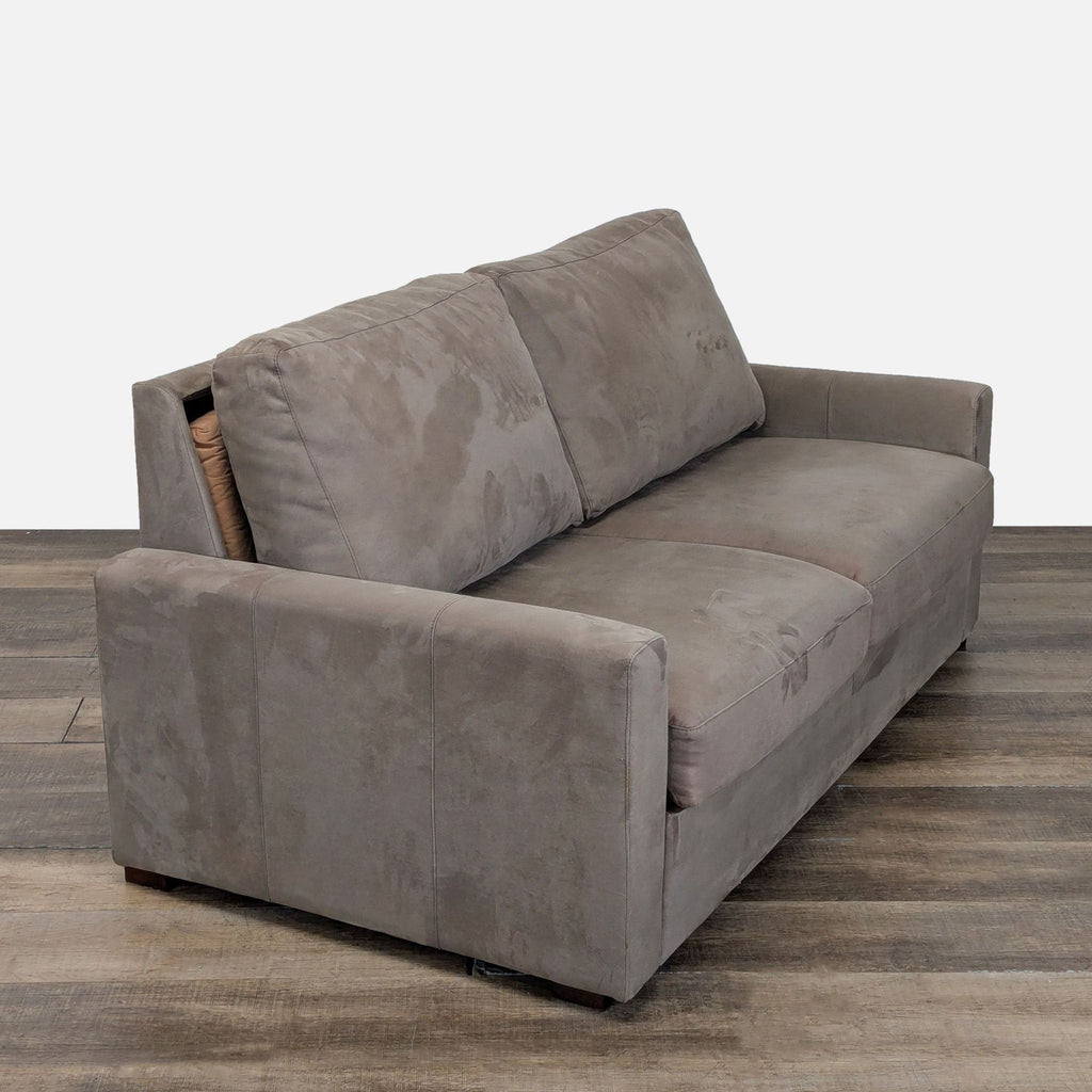 3. Angled view of a Room & Board suede sleeper sofa, highlighting its deep seating and comfortable cushions.