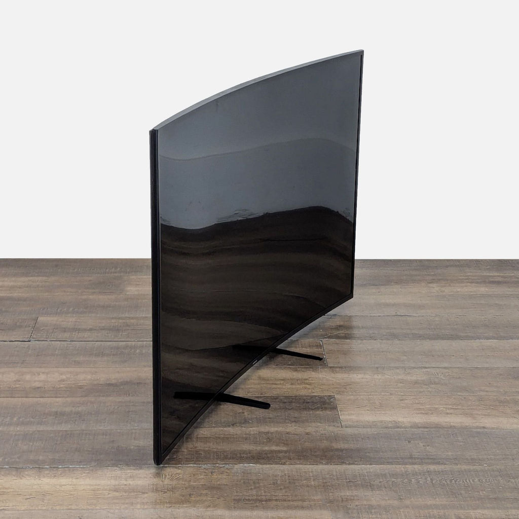 3. Side angle view of a Samsung curved 55-inch Smart TV showing the distinctive curvature and modern slim design.