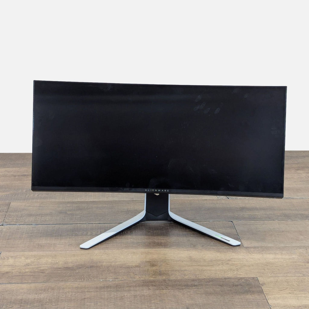 1. Front view of Alienware curved ultrawide gaming monitor with sleek black bezel and wide display screen.