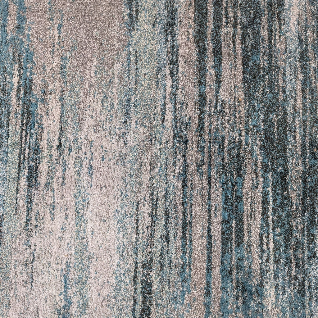 2. Close-up of Dalyn rug texture, highlighting the blue and grey abstract pattern and soft polypropylene fibers.
