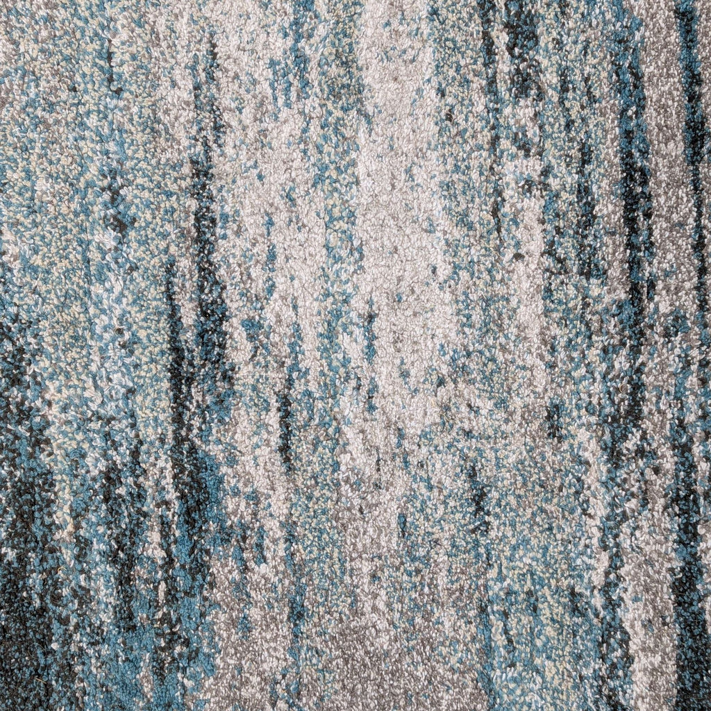 2. Close-up of Dalyn rug surface, displaying dense 1/2” pile with mixed blue, gray, and ivory tones.  