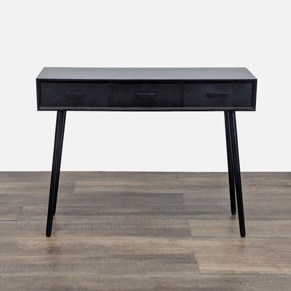 1. Black Reperch side and console table with three drawers and angled legs, shown on a wooden floor.