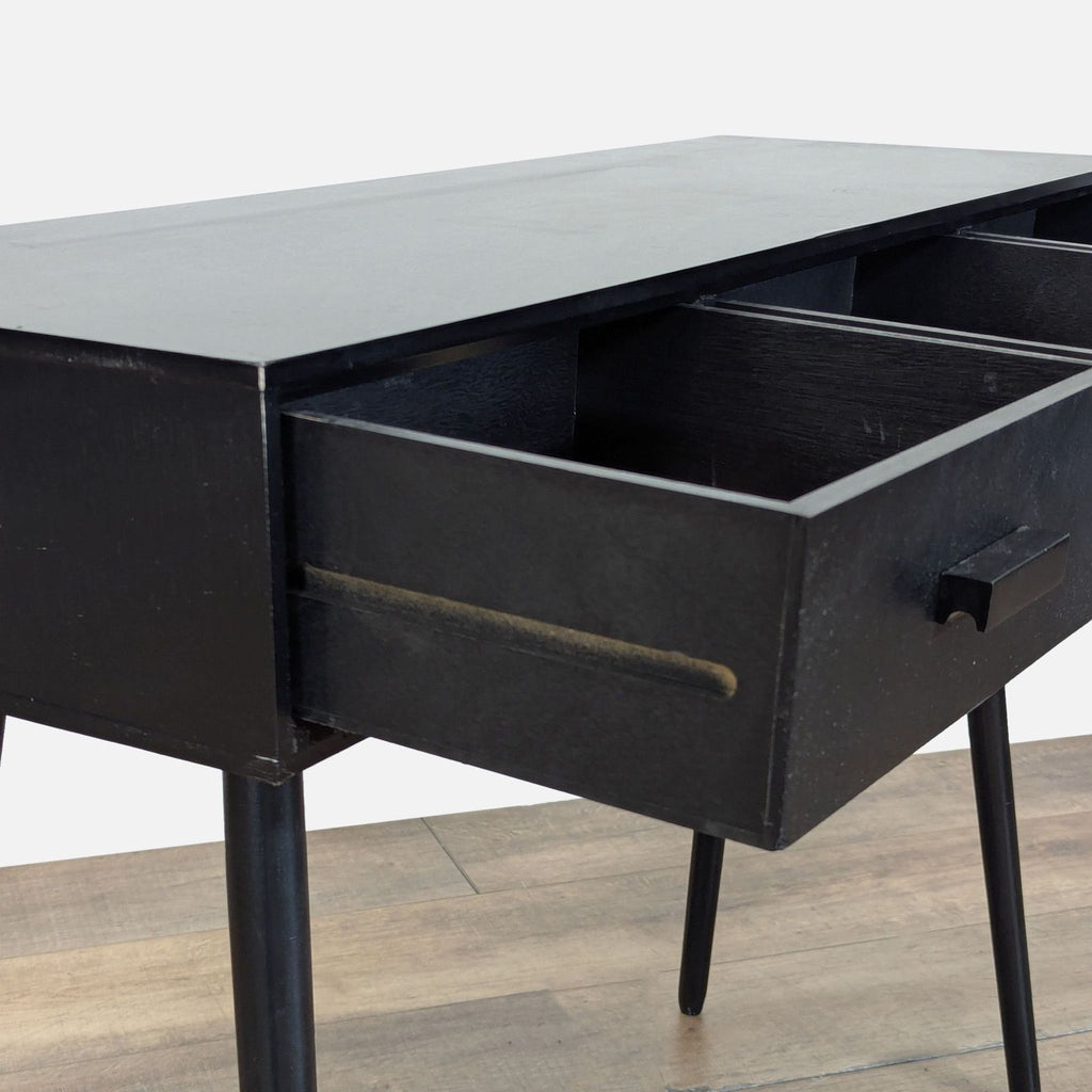 3. Close-up of Reperch side table's open drawer, highlighting textured black wood and simple modern design.