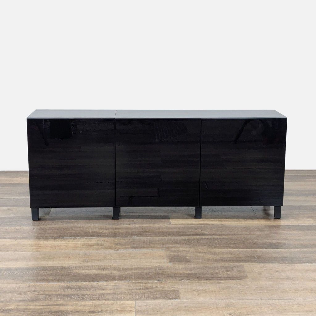 1. Black Ikea sideboard with sleek, glossy finish and three front-facing cabinet doors, shown on wooden floor.