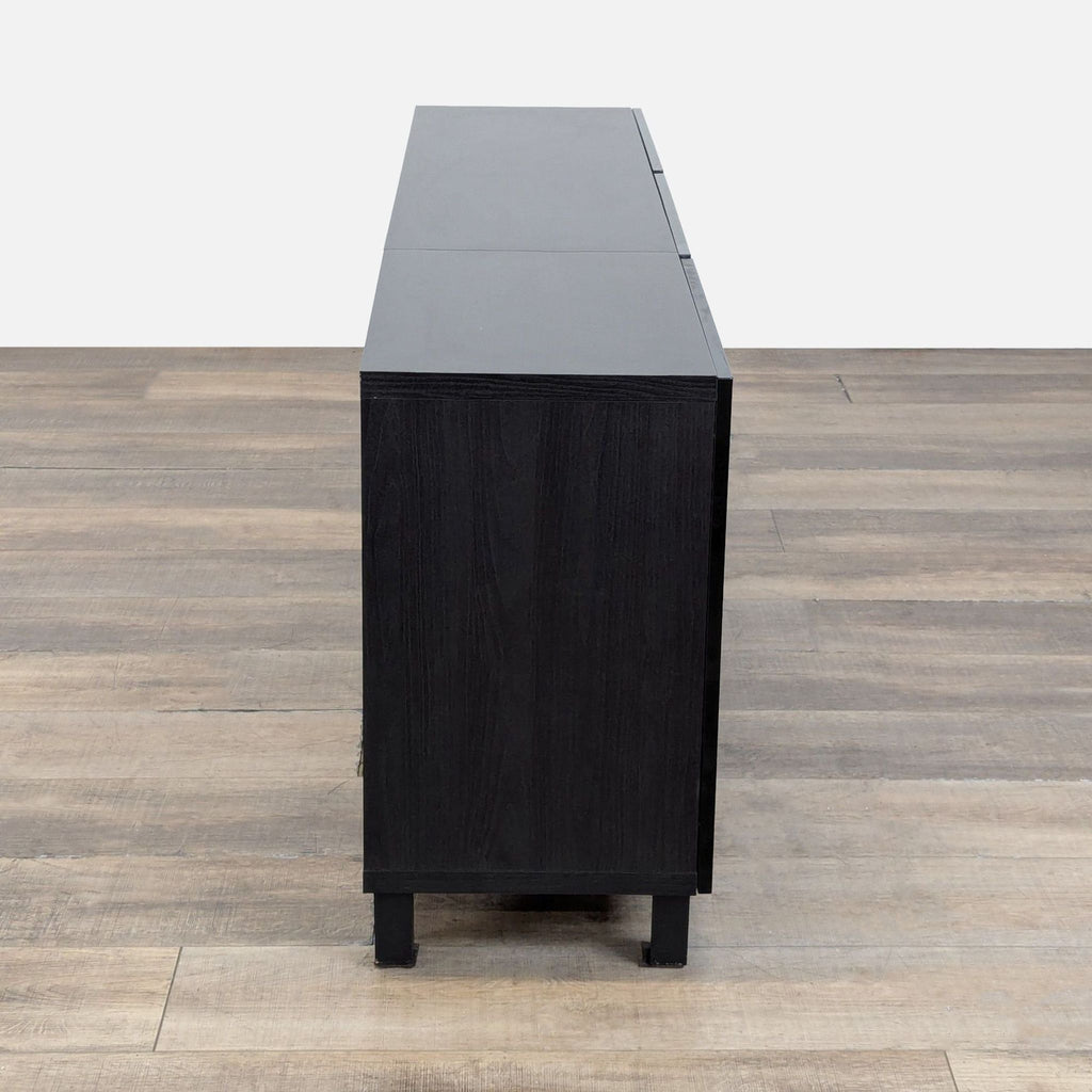 3. Side profile of a modern Ikea sideboard, highlighting its clean, rectangular shape and dark wood grain finish.