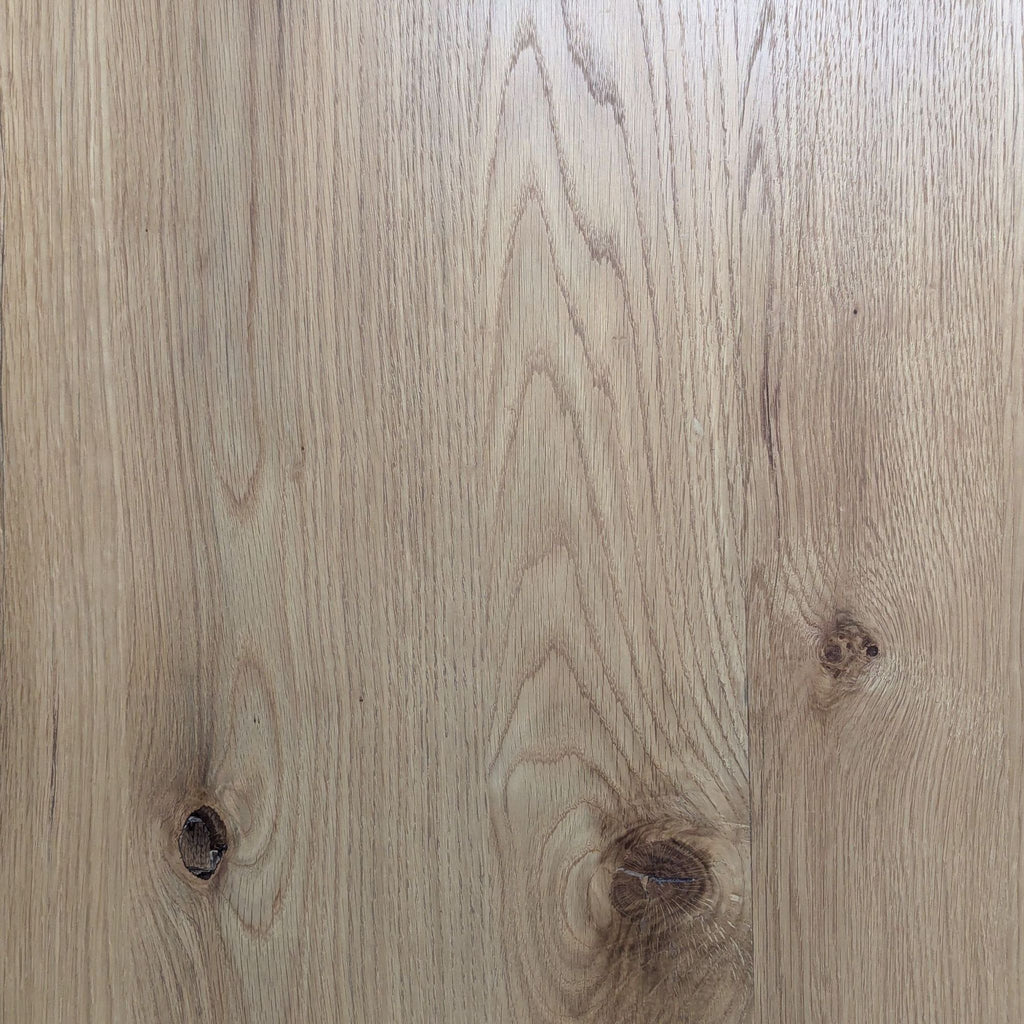 Detailed view of the Reperch coffee table’s natural wood grain and knots on the smooth tabletop surface.