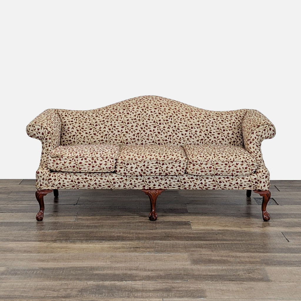 Front view of a Reperch 3-seat sofa with floral upholstery and ball and claw wood feet.  