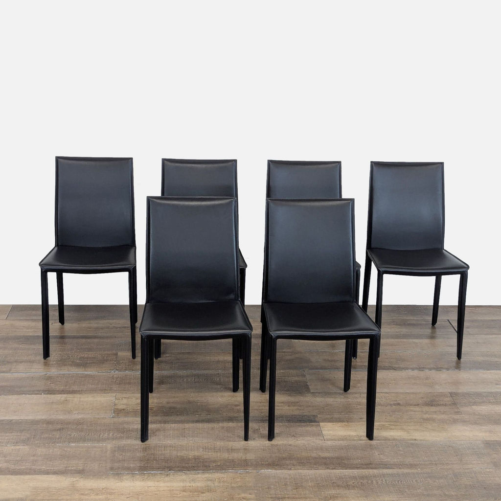 1. Set of six EQ3 black leather dining chairs with sleek, modern design on wooden floor.  