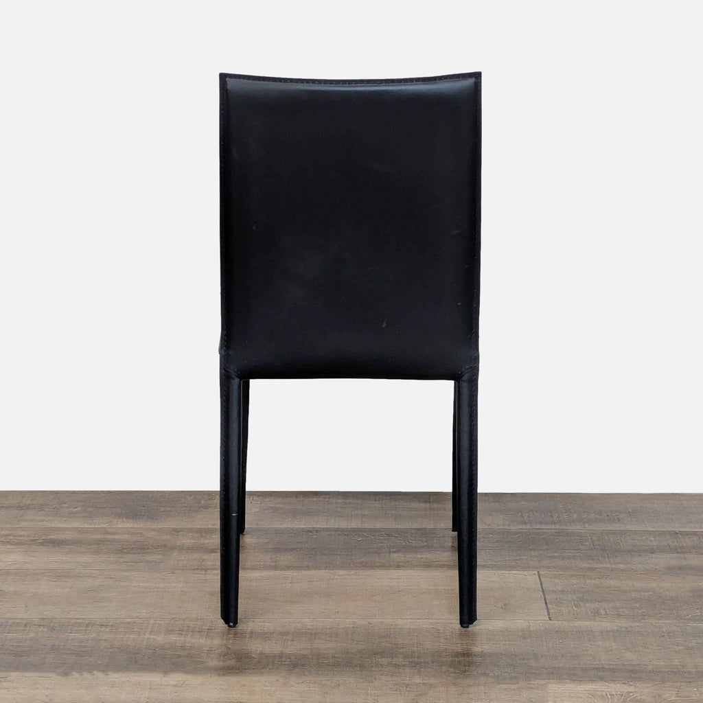 2. Single EQ3 dining chair in black leather, shown from the front against a plain background.  