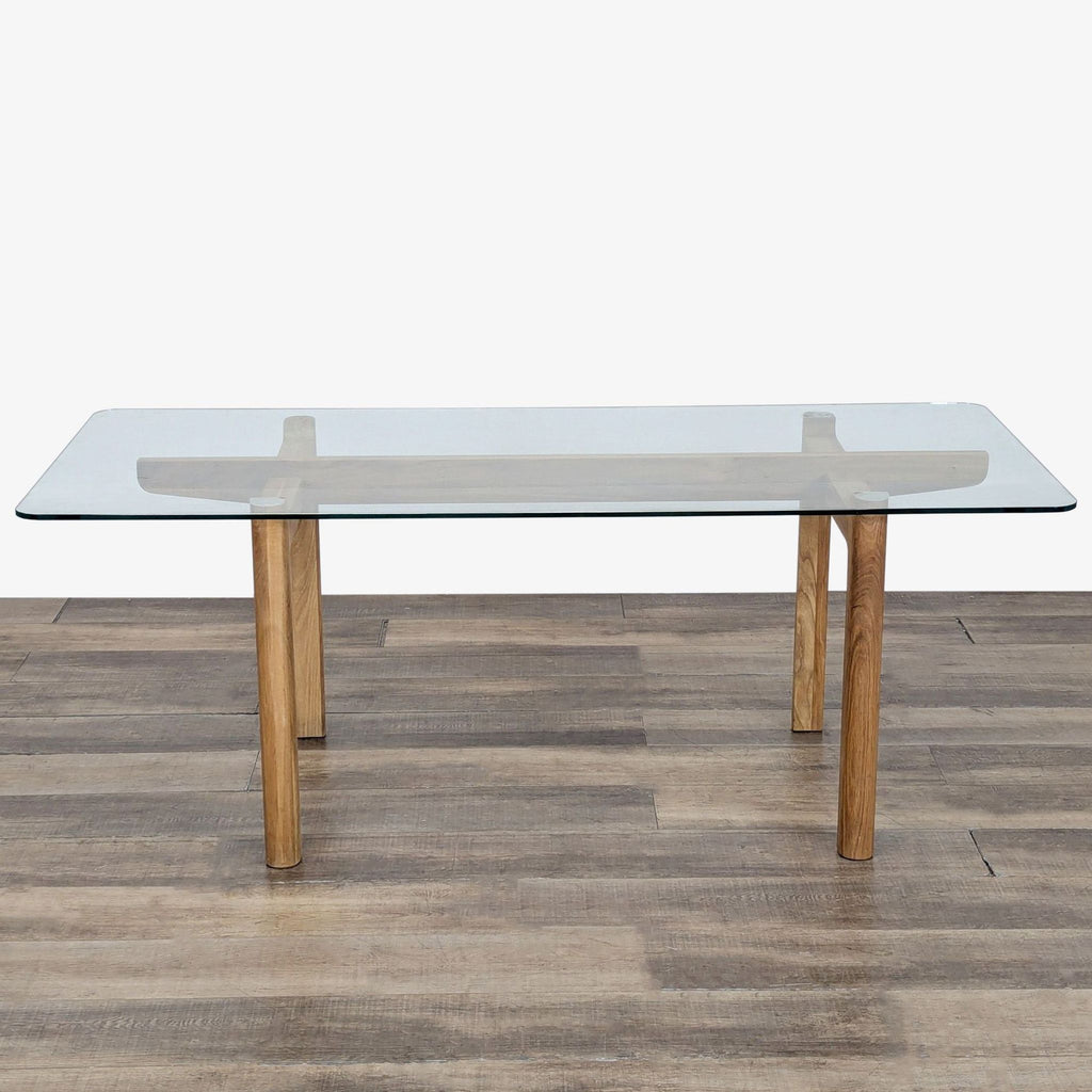 1. EQ3 dining table by Shawn Place with an oak base and a clear rectangular glass top, shown from the front.