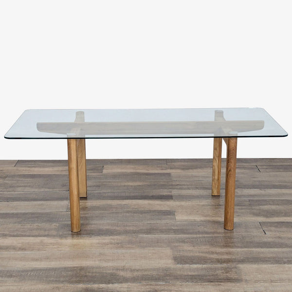 1. EQ3 dining table by Shawn Place with an oak base and a clear rectangular glass top, shown from the front.